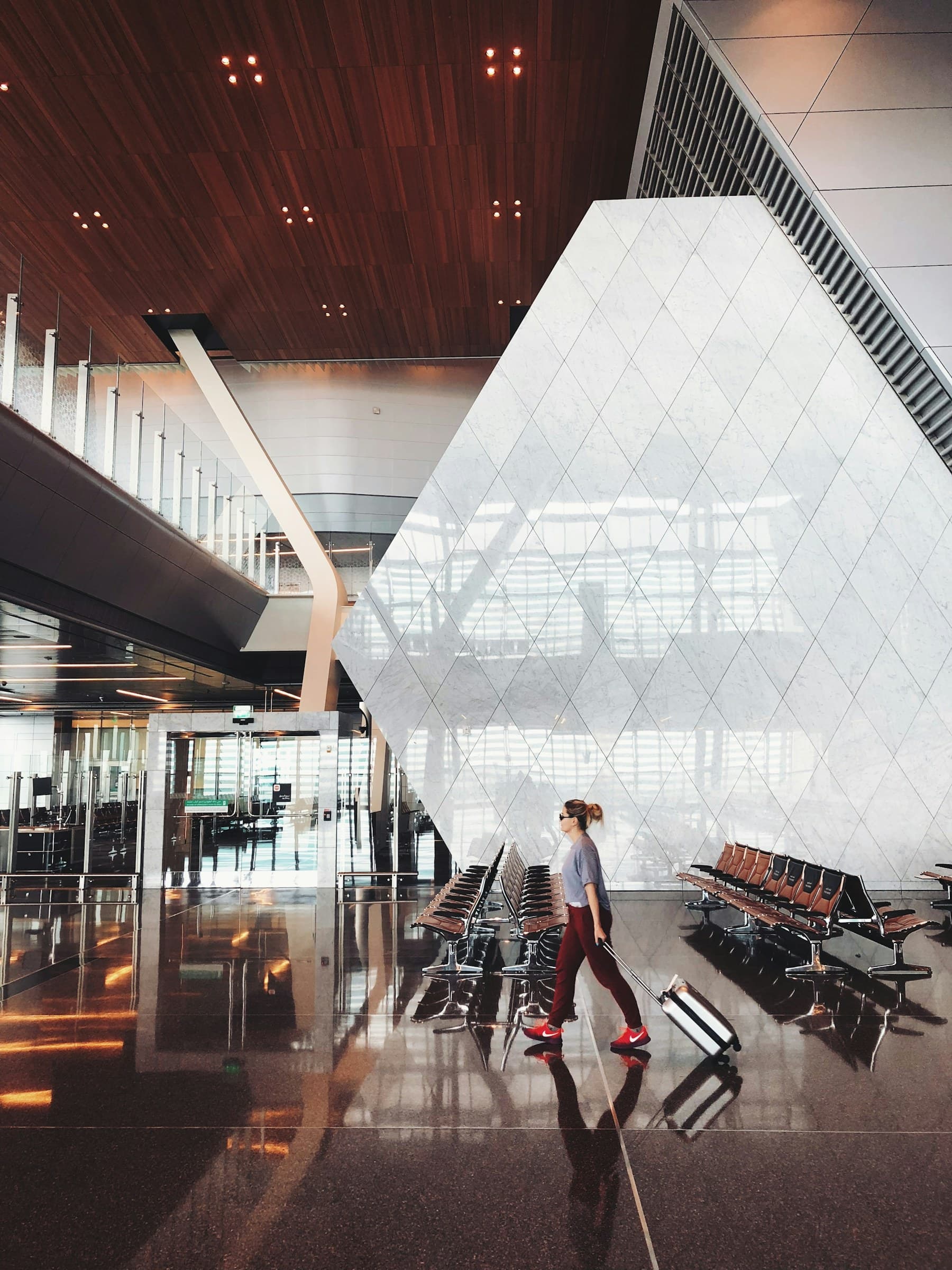 A traveller walking through a spacious airport