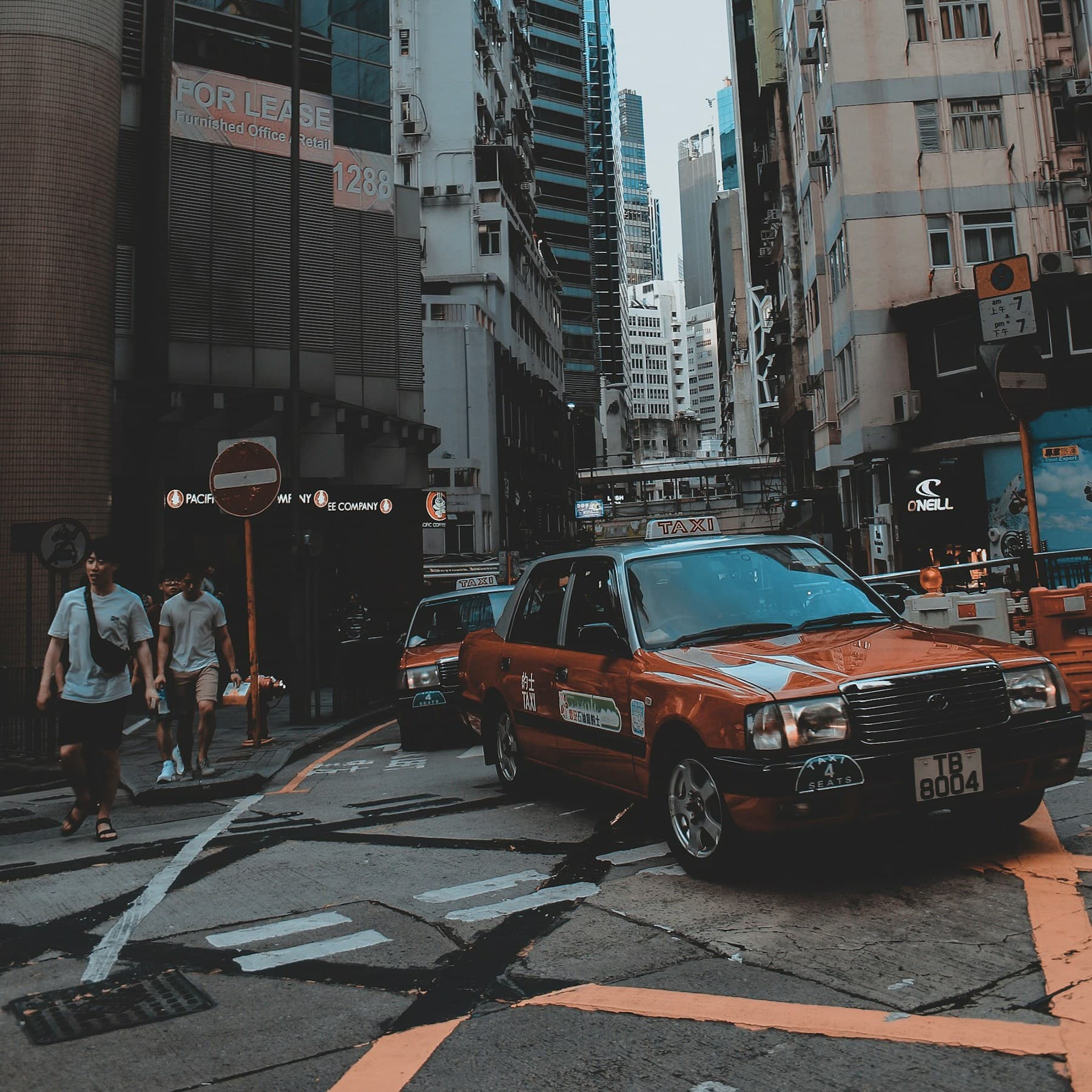 Taxis moving through a dense city street