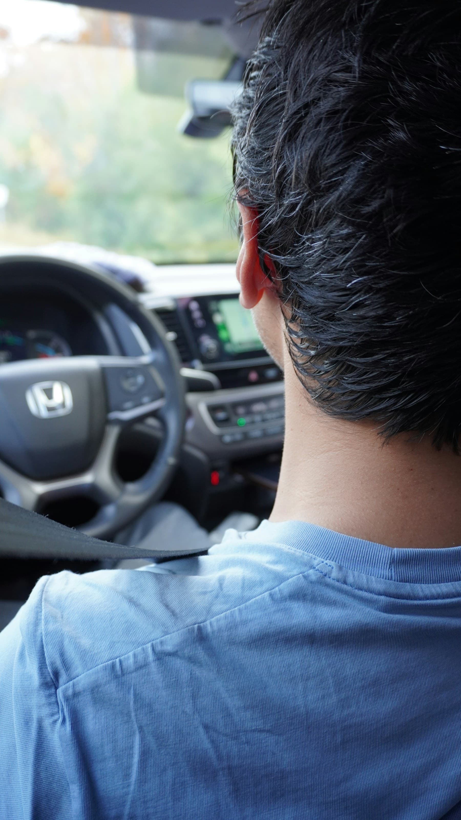 A driver reviewing navigation from the driver's seat