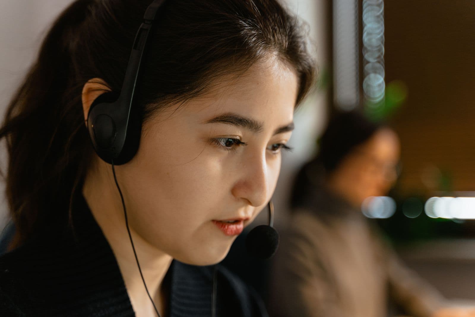 A support specialist taking a call on a headset