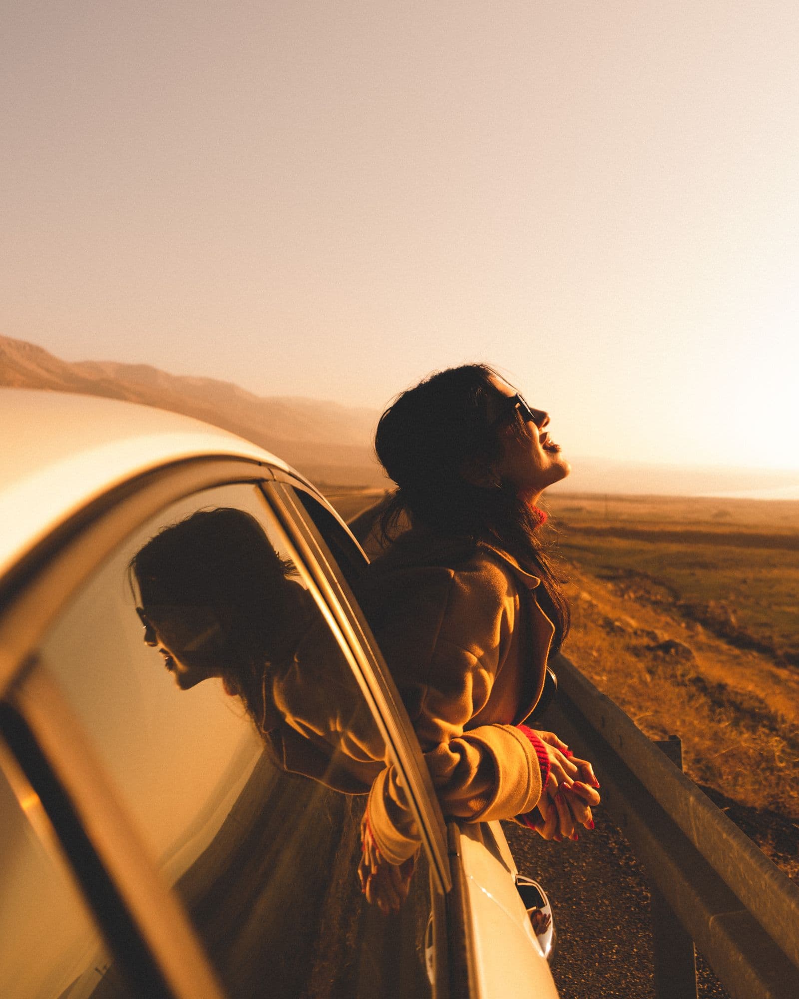 A rider on an open road at golden hour
